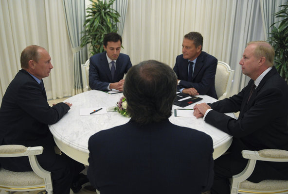 Clockwise from left,  Russian President Vladimir Putin; an unidentified interpreter; Carl-Henric Svanberg, the chairman of BP;  Robert  Dudley, BP's chief executive; and  Igor Sechin, the Rosneft chairman. The officials met on Tuesday at the Black Sea resort of Sochi.