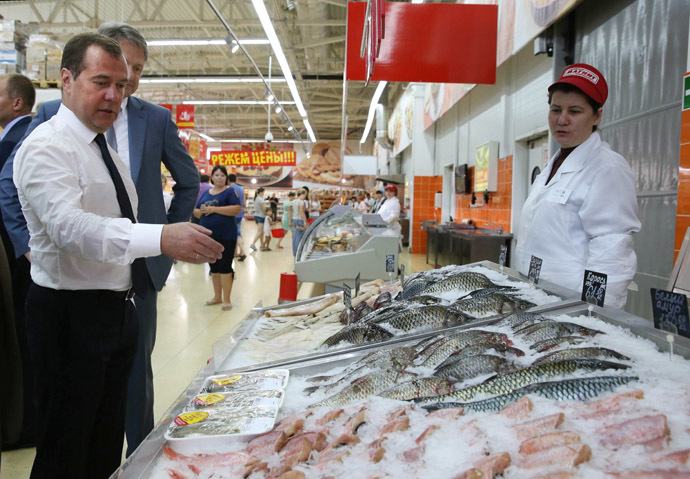 Russian Prime Minister Dmitry Medvedev, left, visits a Magnit supermarket in the town of Korenovsk. (RIA Novosti/Ekaterina Shtukina)