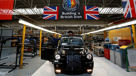 A worker checks a TX4 at the end of the production line at the London Taxi Company in Coventry, central England © Darren Staples