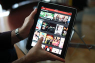 Streaming movies on an iPad. Netflix gained two million American subscribers to its streaming service in the fourth quarter.