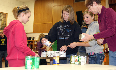 Church youth group members sort canned items for a food drive in Montana.