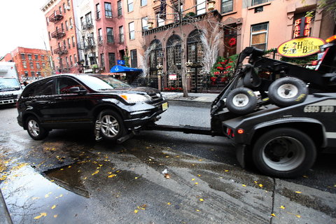 A car being towed in New York City.
