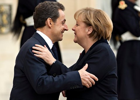 President Nicolas Sarkozy of France greeting Chancellor Angela Merkel of Germany in Paris on Monday.