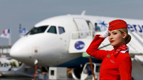 A cabin crew member of Russian carrier Aeroflot poses in front of a Sukhoi Superjet 100 airplane © Pascal Rossignol