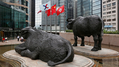 (L-R) The Hong Kong Exchanges flag, Chinese national flag and Hong Kong flag are hoisted outside the Hong Kong Stocks Exchange in Hong Kong. © Bobby Yip