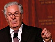 Mervyn King, the governor of the Bank of England, criticized banks that were considering paying bonuses later than usual.