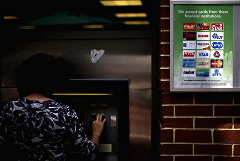 A woman uses an ATM in Atlanta.