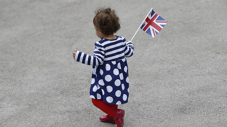 A toddler with a Union flag at a 