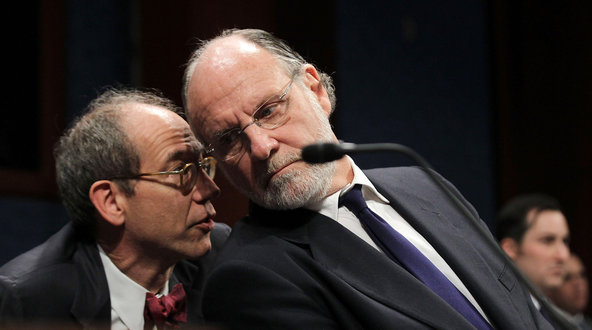 Jon S. Corzine, right, MF Global's former chief executive, consults with an aide during his testimony before a House hearing on his firm's demise.