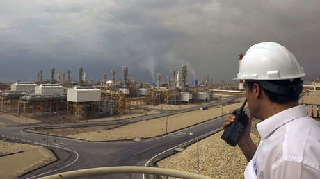An engineer speaks on his radio at the Phase 4 and Phase 5 gas refineries in Assalouyeh, 1,000 km (621 miles) south of Tehran © Caren Firouz