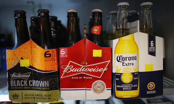Six packs of Anheuser-Busch's Budweiser and Grupo Modelo's Corona Extra beers.