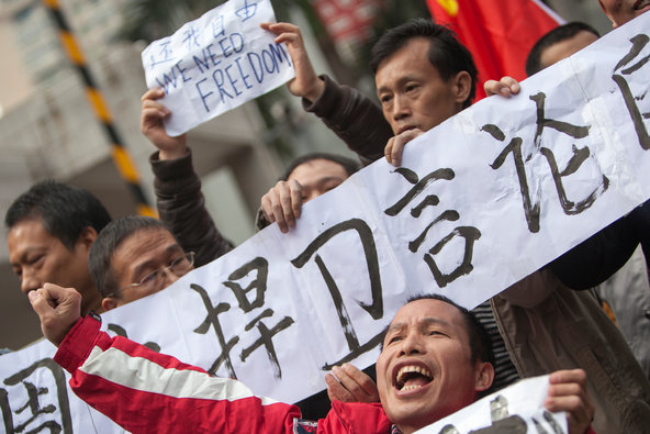 Xiao Qinshan, foreground, demonstrated for free speech from his wheelchair at the offices of the publisher of Southern Weekend in Guangzhou, China.