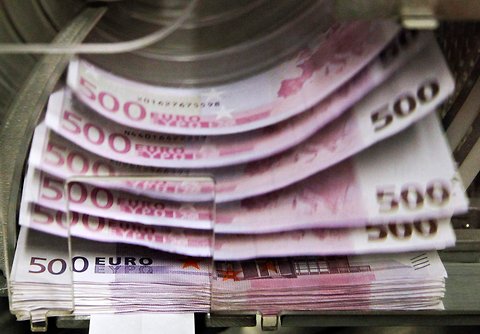 A machine counts and sorts euro notes at the Belgian Central Bank in Brussels.