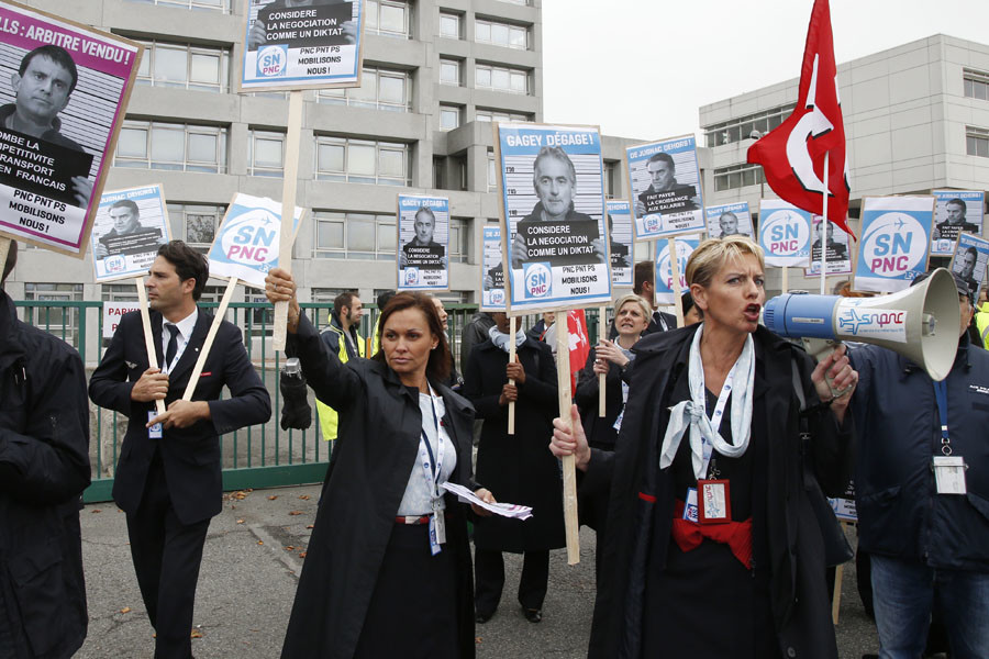 Striking employees of Air France demonstrate in front of the Air France headquarters building at the Charles de Gaulle International Airport in Roissy, near Paris, France, October 5, 2015. © Jacky Naegelen