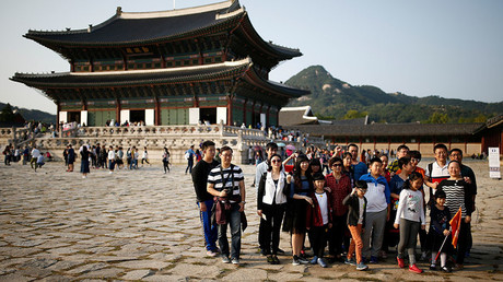 Chinese tourists pose for a group photo at the Gyeongbok Palace in central Seoul, South Korea. © Kim Hong-Ji