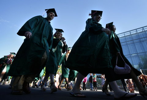 University of Oregon students head to graduation ceremonies last month.