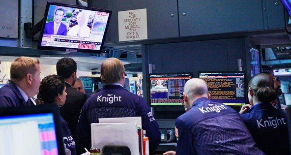 Traders from the Knight Capital Group watched from the floor of the New York Stock Exchange as Knight's chief, Thomas Joyce, was interviewed on television.