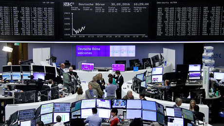 Traders work at their desks in front of the German share price index, DAX board, at the stock exchange in Frankfurt, Germany, September 30, 2016 © Remote