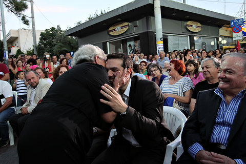 A woman kisses the head of Alexis Tsipras, the leader of Syriza, or Radical Left Coalition, during a pre-election rally in Elefsina, Greece.