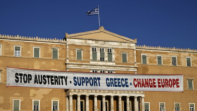 A banner hangs in front of the parliament during a pro-government rally calling on Greece's European and International Monetary creditors to soften their stance in the cash-for-reforms talks in Athens, June 17, 2015. (Reuters / Yannis Behrakis)