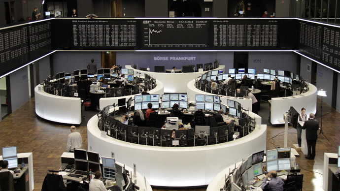 Traders are pictured at their desks in front of the DAX board at the Frankfurt stock exchange. (Reuters/Pawel Kopczynski)