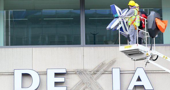 Workers removed the logo from the Dexia's heaquarters in Brussels in February after the Belgian part of the bank was nationalized.