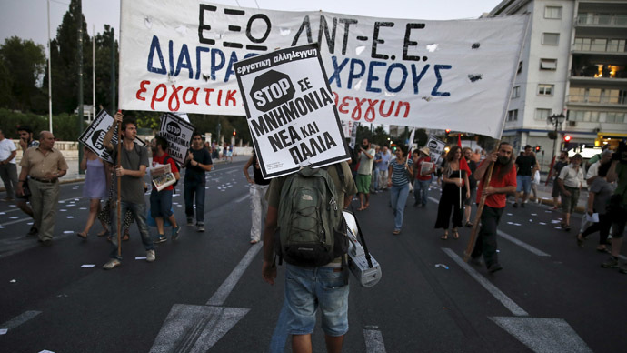 A protester carries a placard that reads Stop to new and old bailouts during an anti-bailout demonstration in Athens, Greece June 25, 2015. (Reuters / Alkis Konstantinidis)