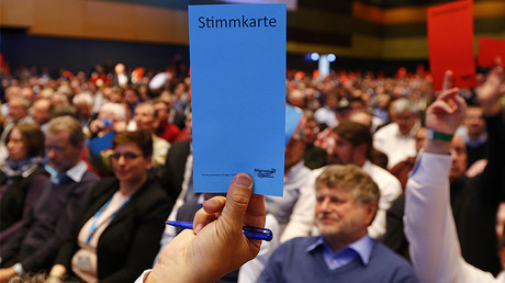 AfD party members hold voting cards during the AfD party congress in Stuttgart, Germany, April 30, 2016. © Wolfgang Rattay