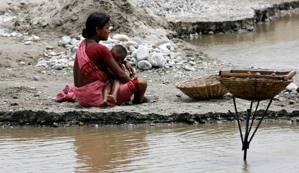 A laborer breastfeeding her child on the banks of the Balason River in India. A new survey ranks India behind even Saudi Arabia in terms of gender equality.