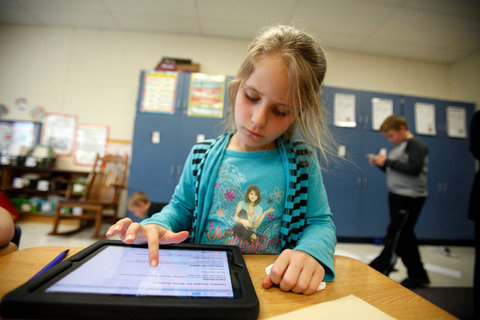 David Maxwell for The New York Times Alexis White, 7, a second grader in Green, Ohio, using an iPad during class. The iPad is gaining popularity as a reading device.