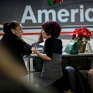 American's counter at La Guardia Airport on Tuesday. The airline says it will run a full schedule while it is in bankruptcy.