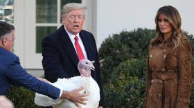 US President Donald Trump pardons one of the Thanksgiving turkeys as first lady Melania Trump looks on, November 26, 2019